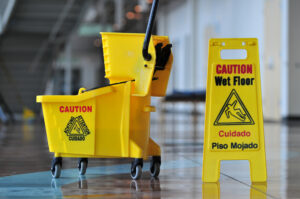 Slip And Fall Facts - Mop bucket and caution sign