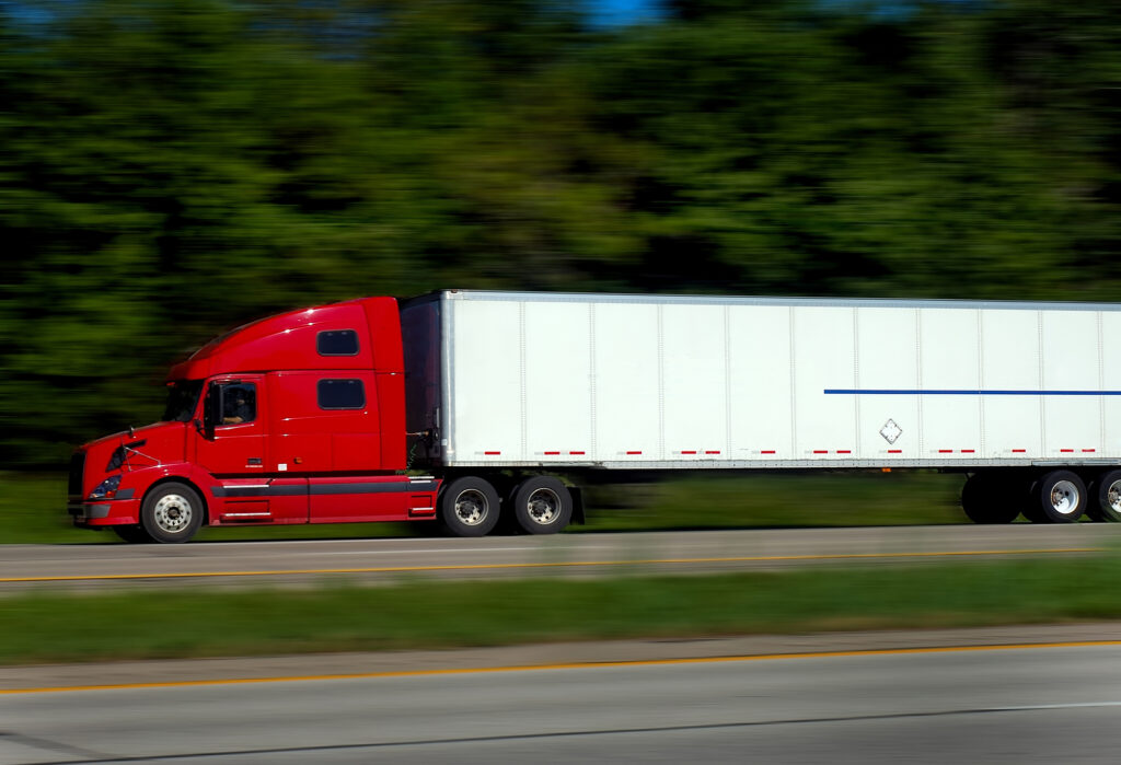 Truck Accident Lawyer Metairie, LA - semi truck on highway side view red